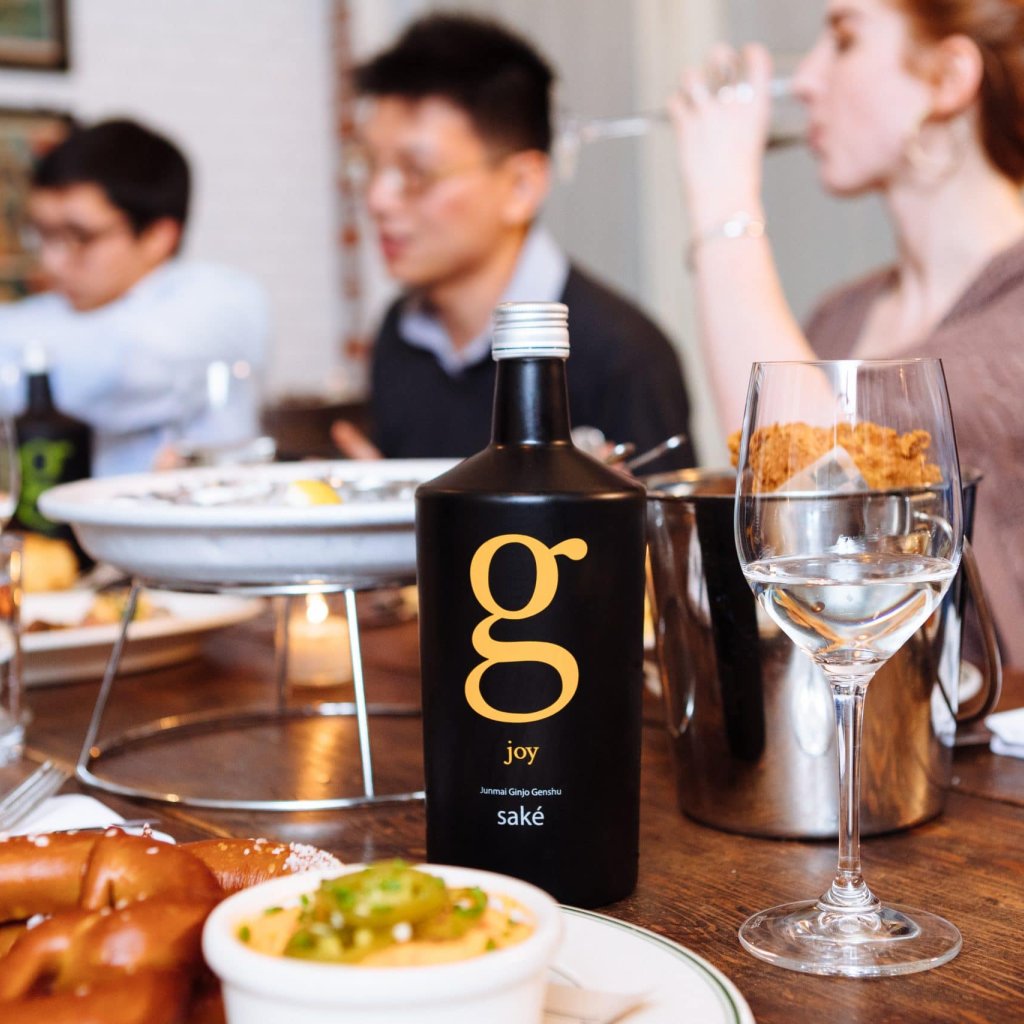 A scene from a SakéOne photoshoot at Woodsman Tavern featuring fried chicken and saké, a surprisingly delightful combination