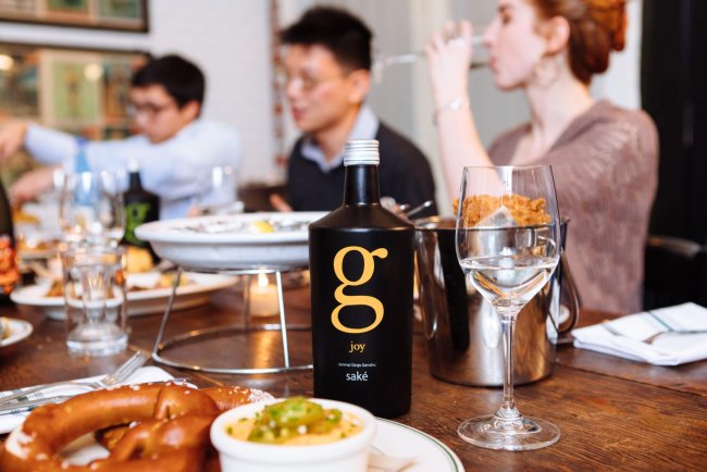 A scene from a SakéOne photoshoot at Woodsman Tavern featuring fried chicken and saké, a surprisingly delightful combination