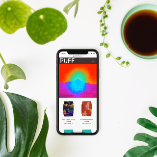 Puff Coffee Homepage on an iPhone with green plants and coffee