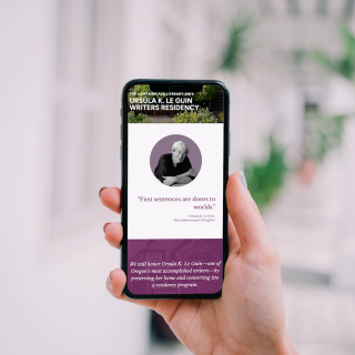Hand holding an iPhone that shows the Ursula K. Le Guin Writers Residency page on the Literary Arts website, featuring the quote "First sentences are doors worlds."