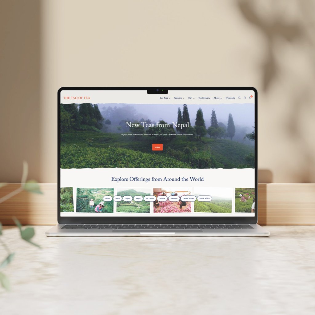Tao of Tea website home page on a laptop, featuring a large image of tea field and smaller images inviting one to explore tea from around the world