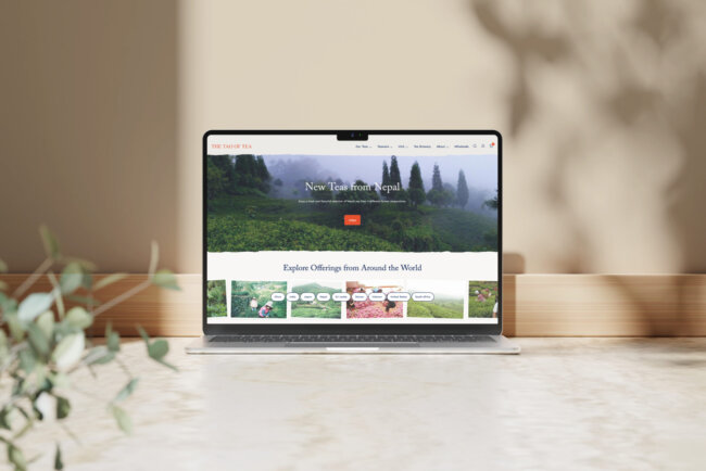 Tao of Tea website home page on a laptop, featuring a large image of tea field and smaller images inviting one to explore tea from around the world